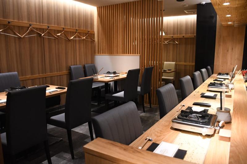 Gion dining room with a wooden counter and table seating