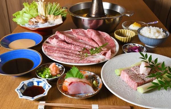A shabu-shabu course with marbled wagyu, dipping sauces, sashimi and rice
