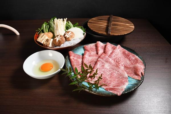 Sliced marbled wagyu with raw egg and vegetables